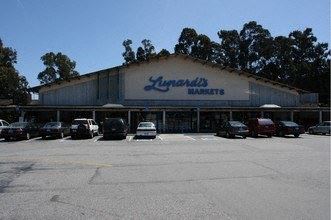a large building with cars parked in a parking lot